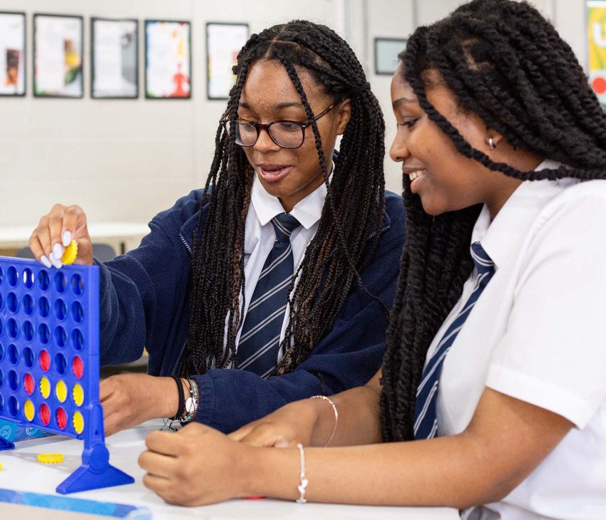 schoolchildren playing games at breakfast