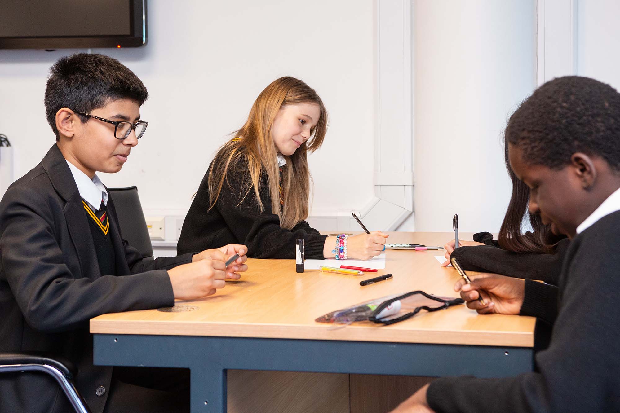 schoolchildren working at a desk