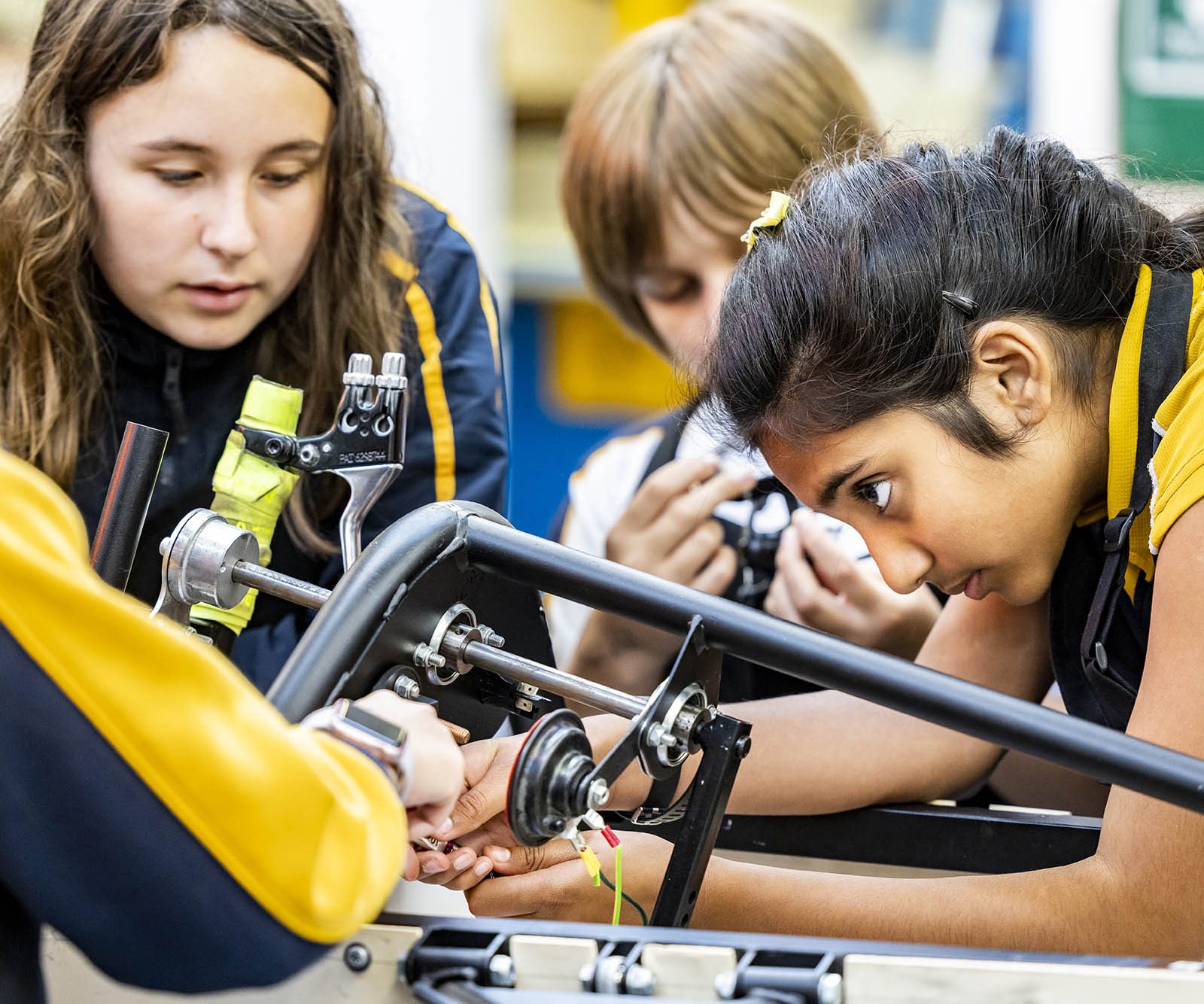 Children repairing a mechanical device