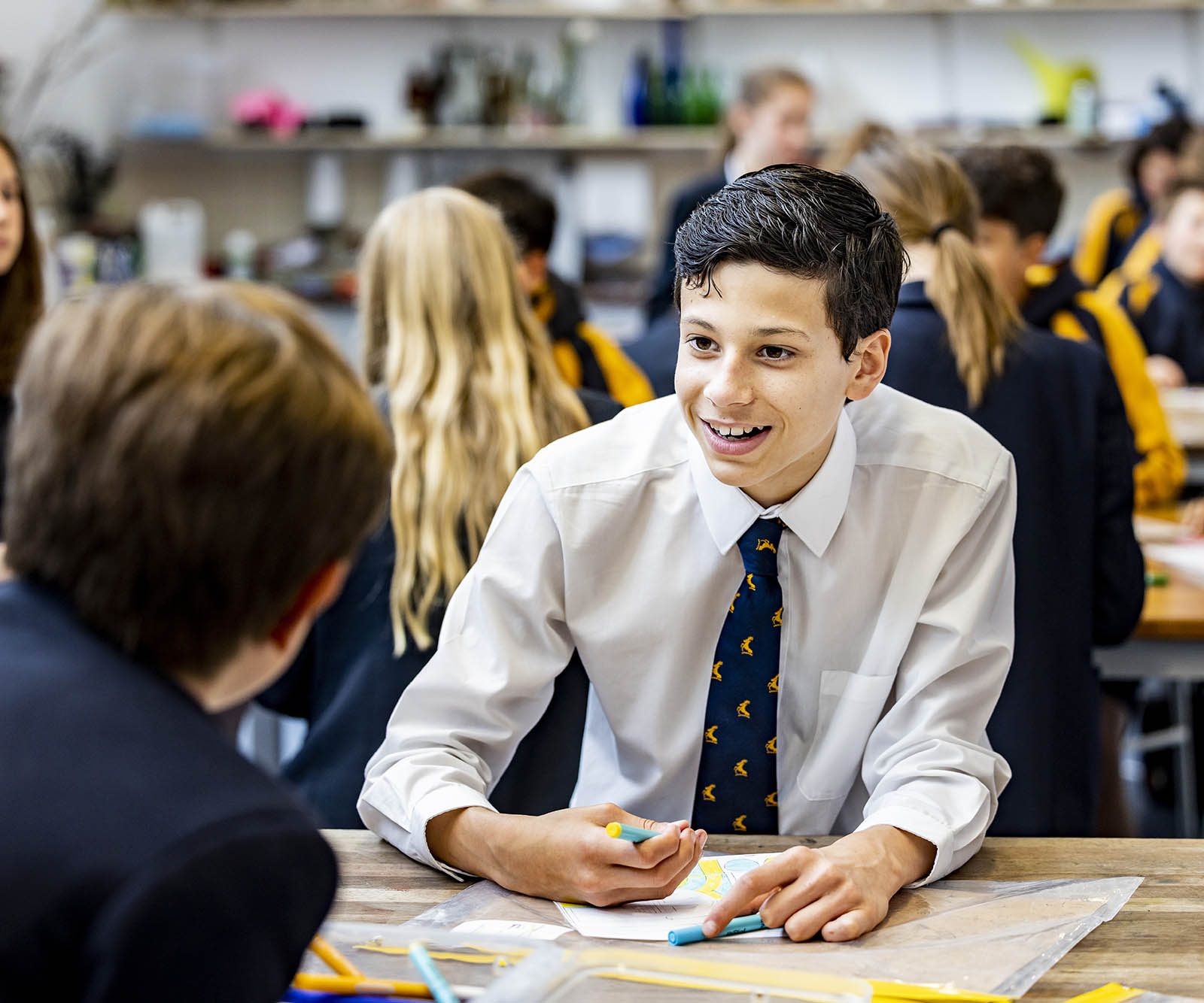 boy in school uniform writing
