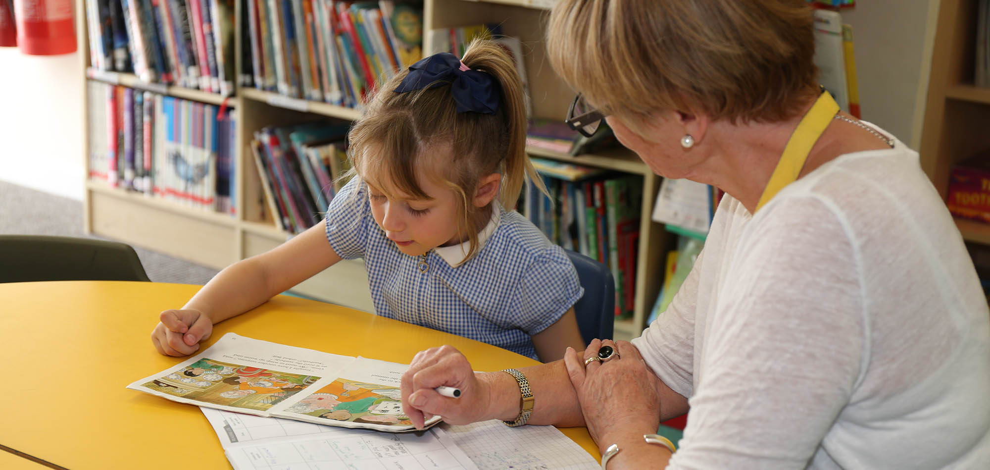 A woman reading with a child