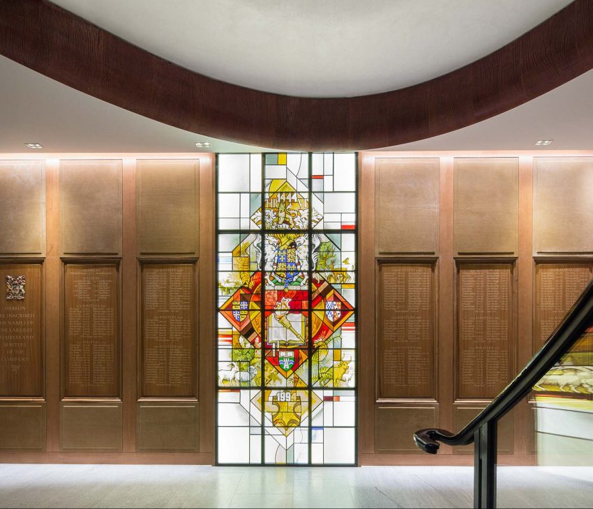 a staircase leading to a stained glass window