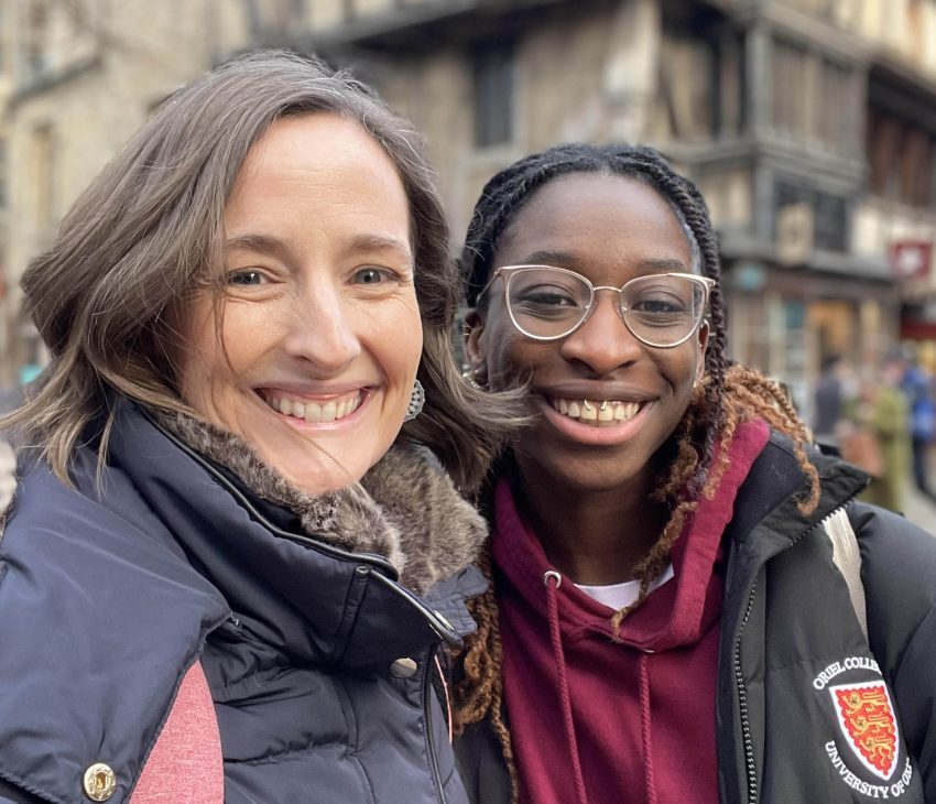 a woman and girl smiling to camera