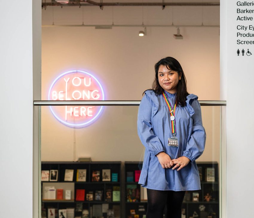 woman in a gallery near a balcony