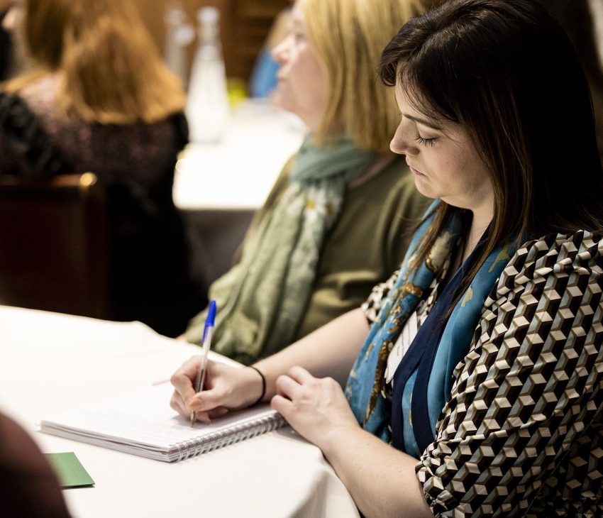 woman taking notes