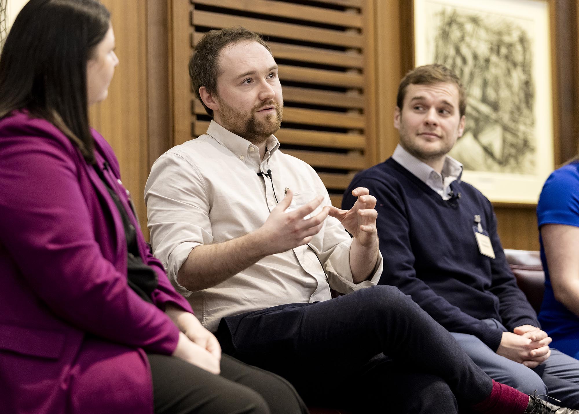 man speaking on a panel during an event
