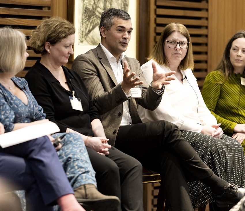 a man speaks on a panel