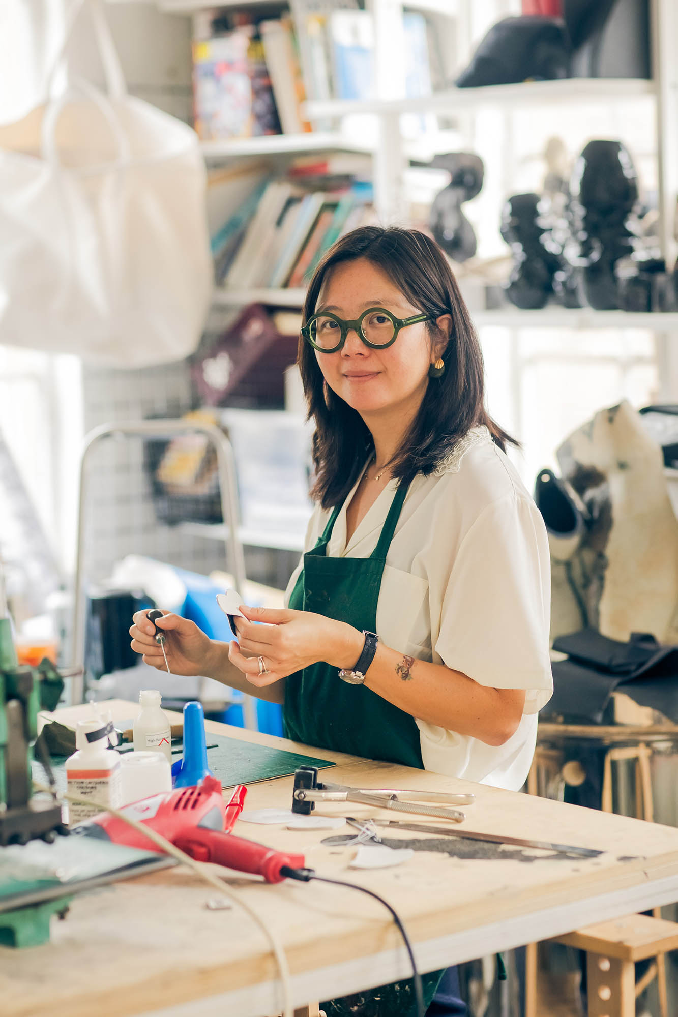 woman in a studio making leather goods