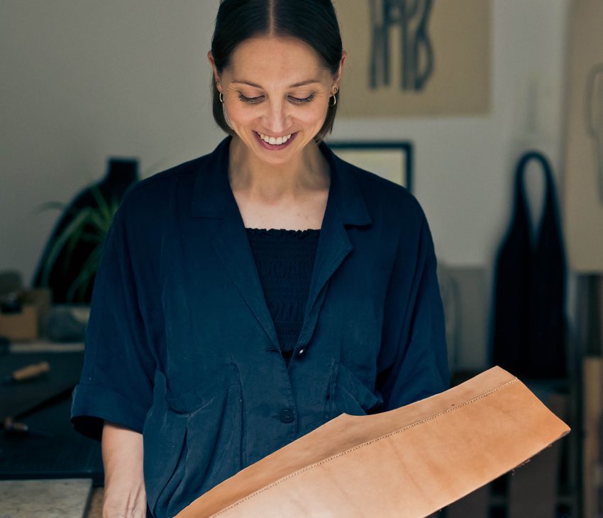 woman holding a leather sculpture