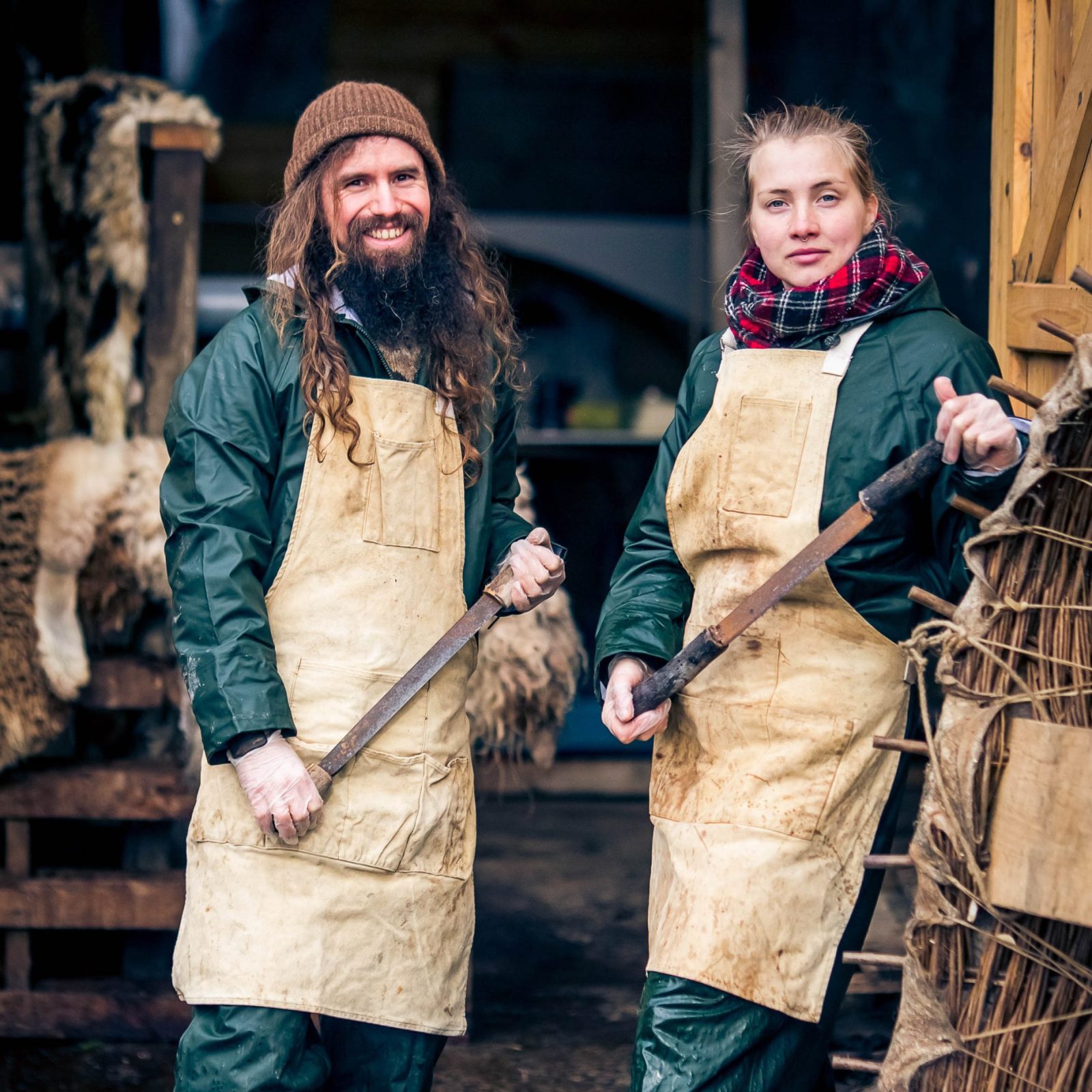 man and a woman wearing overalls and aprons