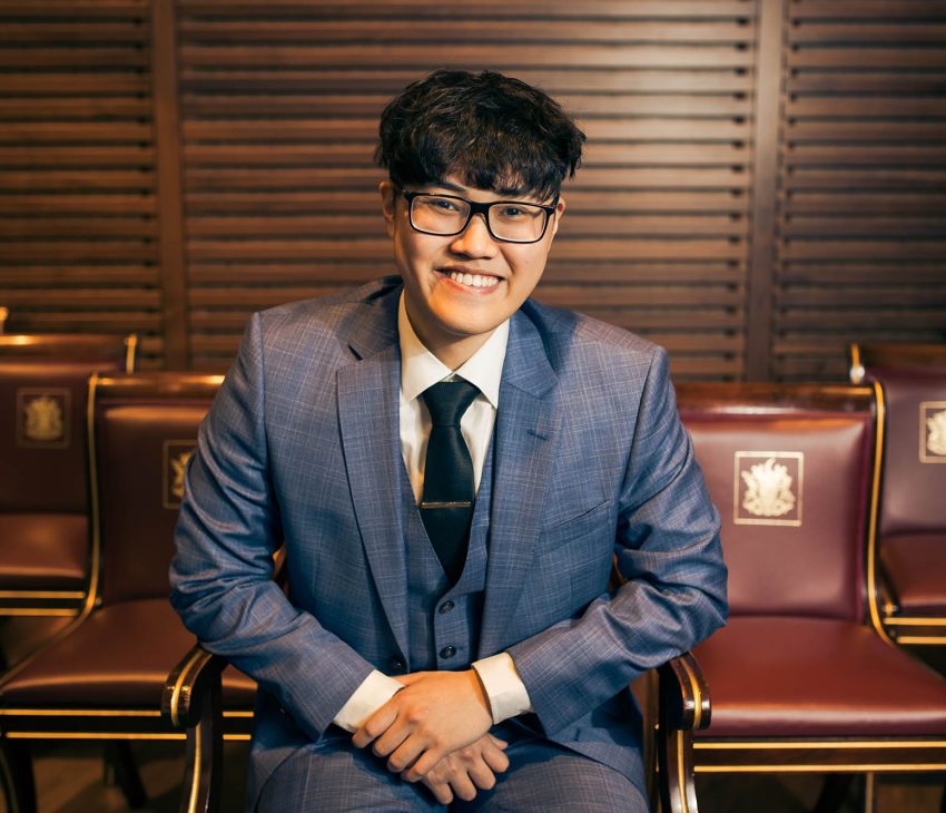 man in blue suit smiling