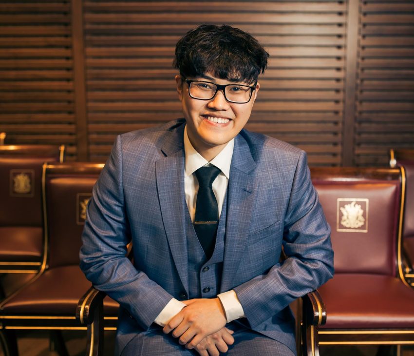 man in blue suit smiling