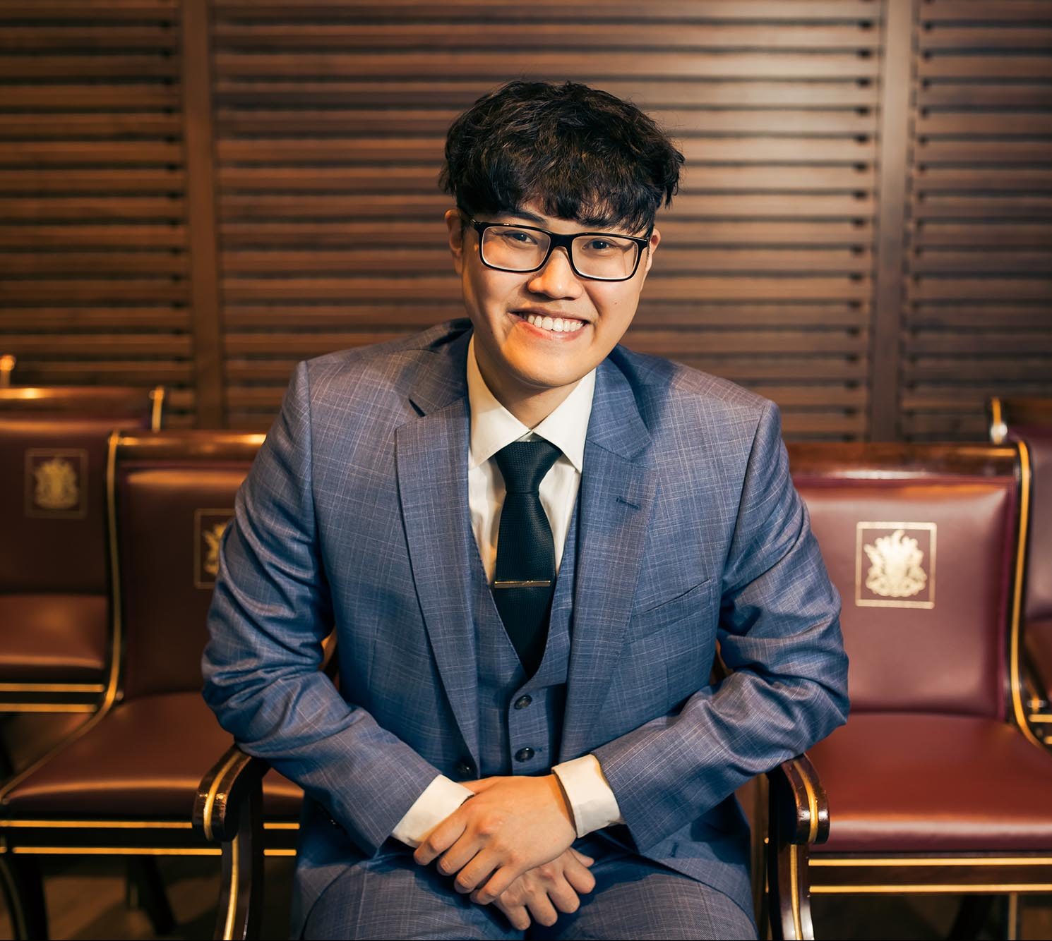 man in blue suit smiling