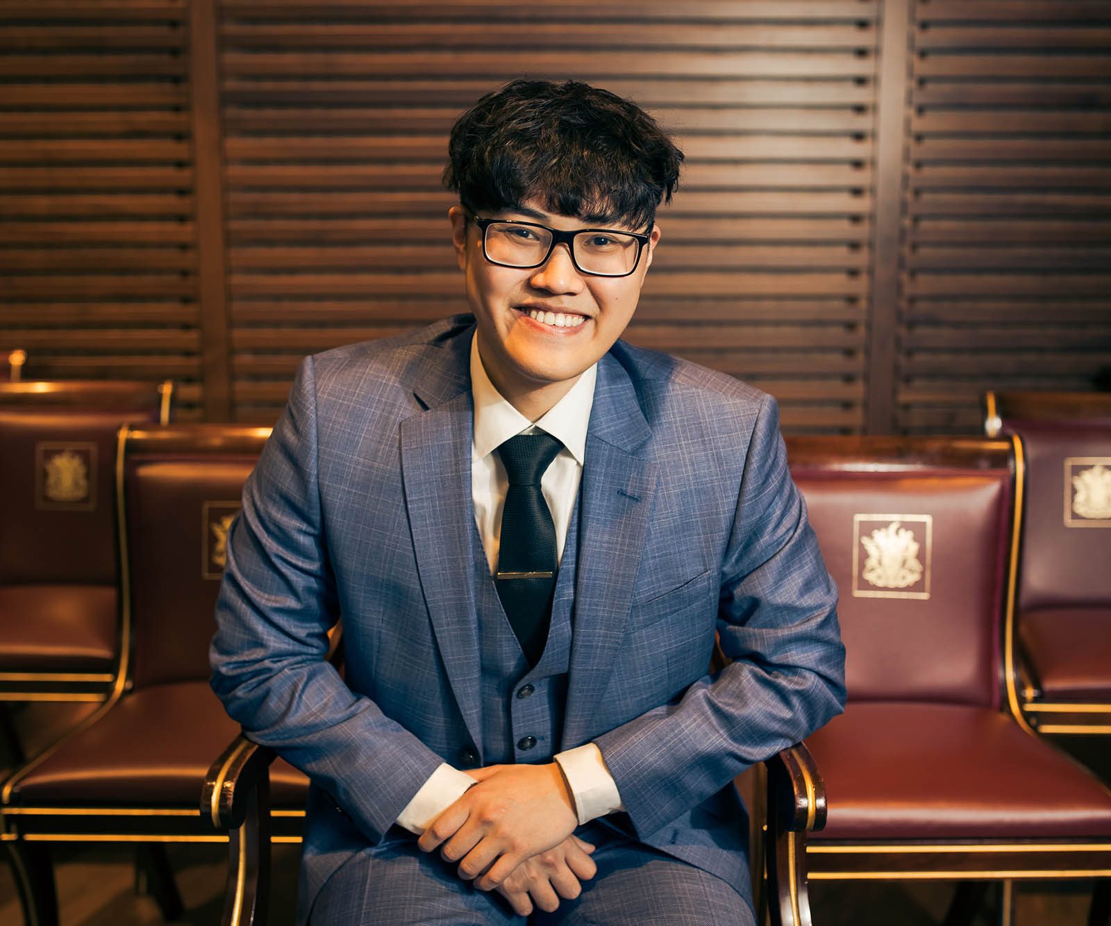 Man in blue suit smiling
