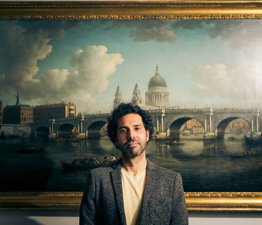 man standing in front of painting