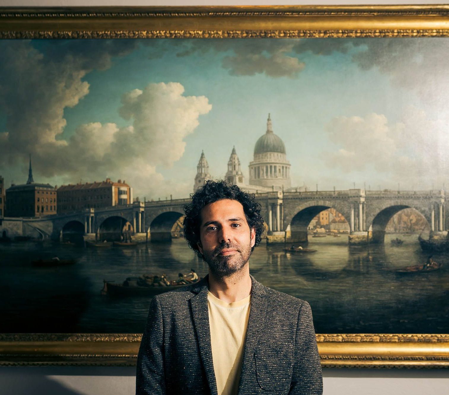 man standing in front of painting