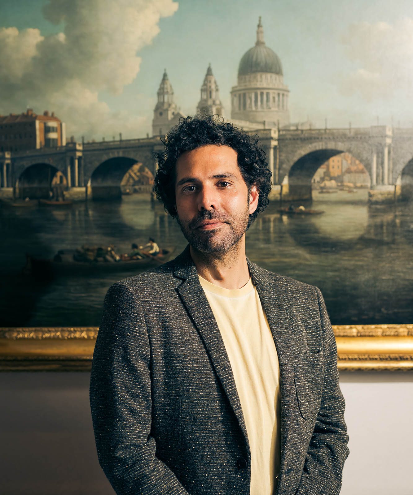 man standing in front of painting