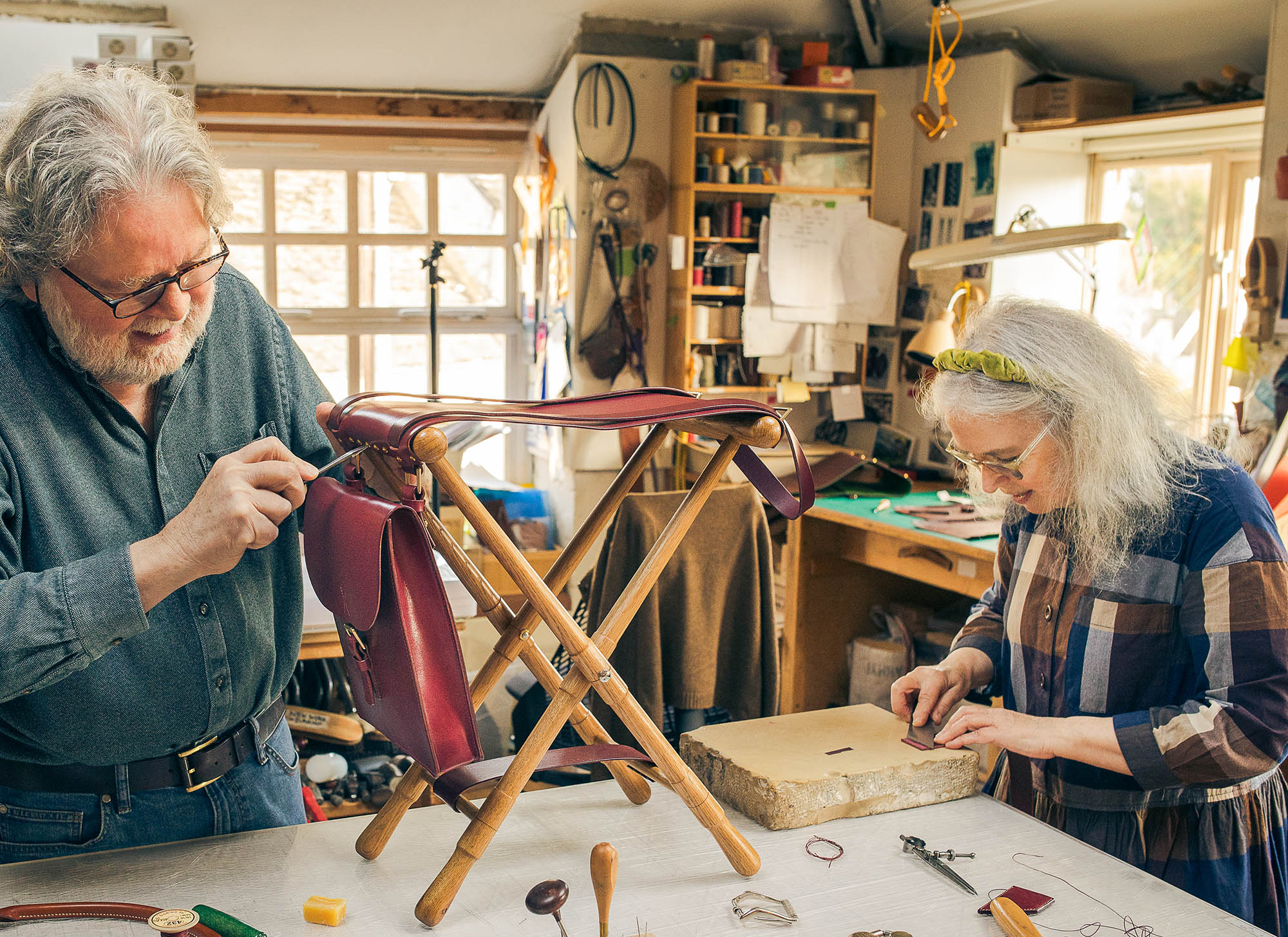 and man and a woman working on a leather chair