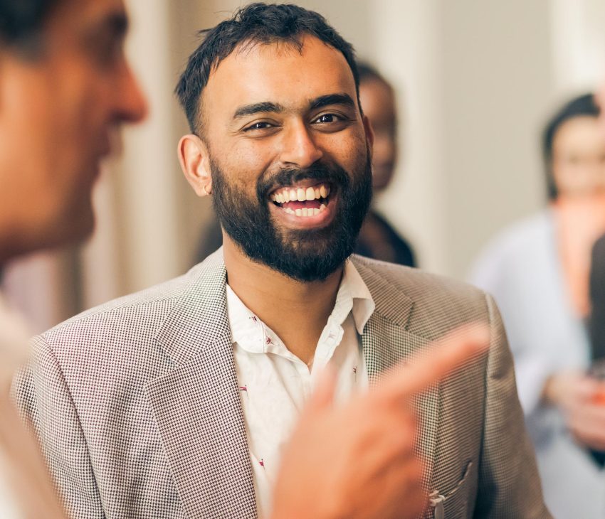 man at an event laughing