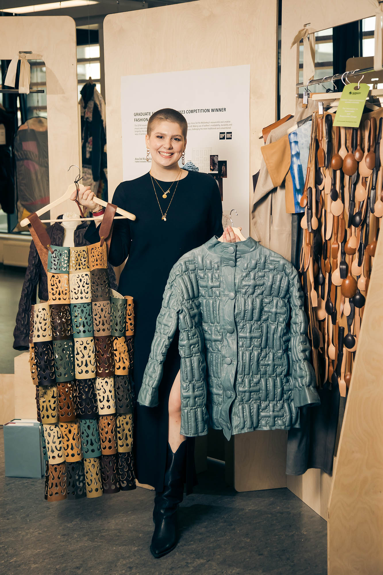 woman holding up leather garments