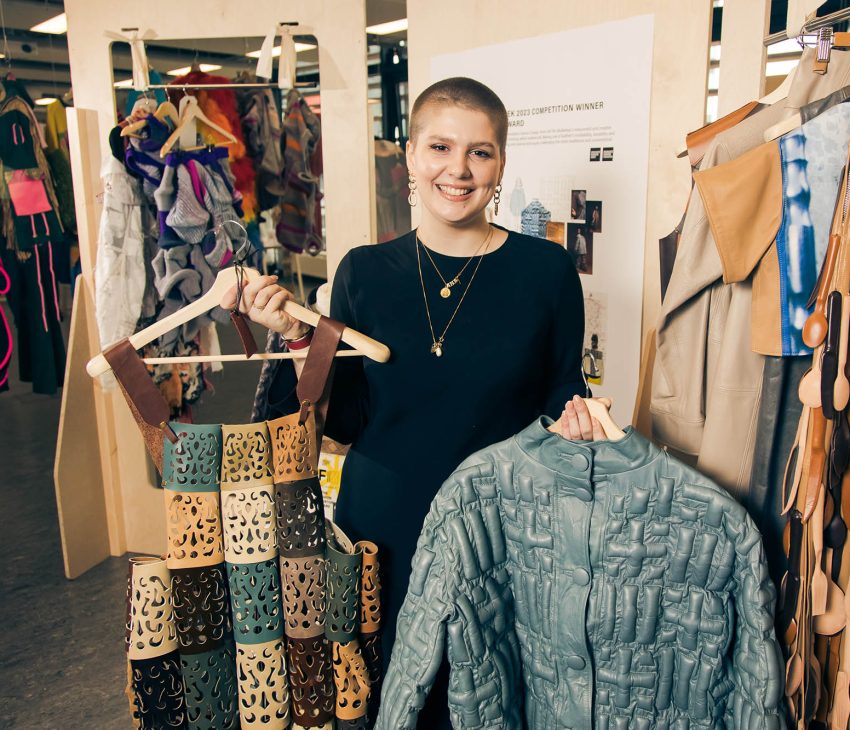 woman holding leather garments