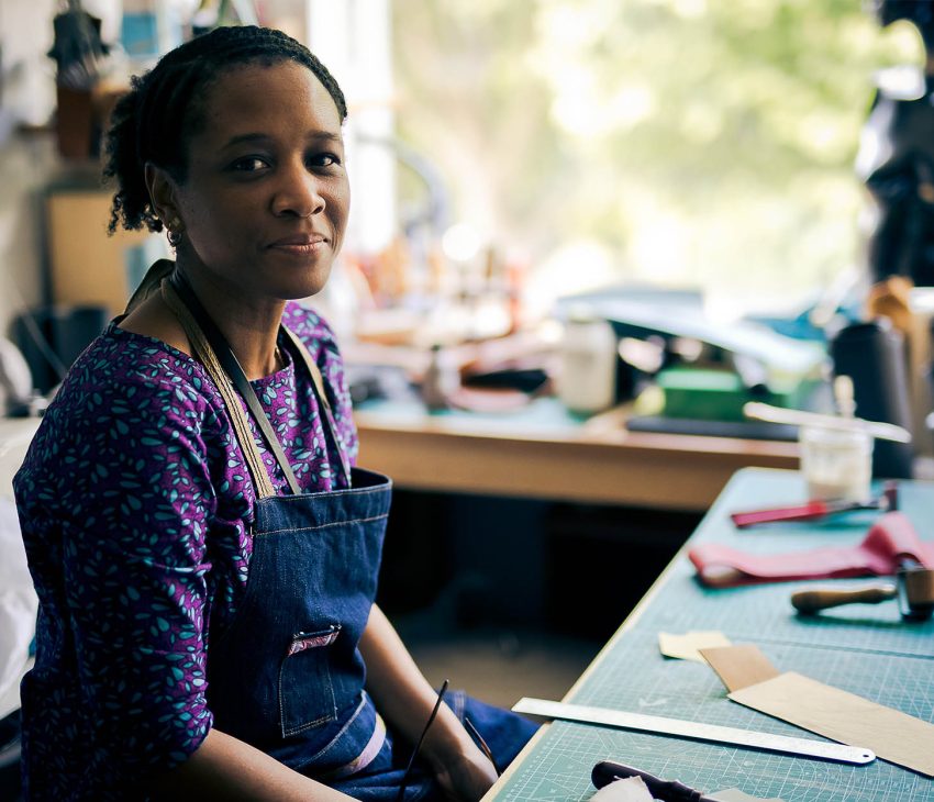 woman in a workshop with tools on a desk
