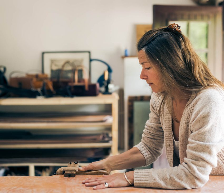 woman cutting leather