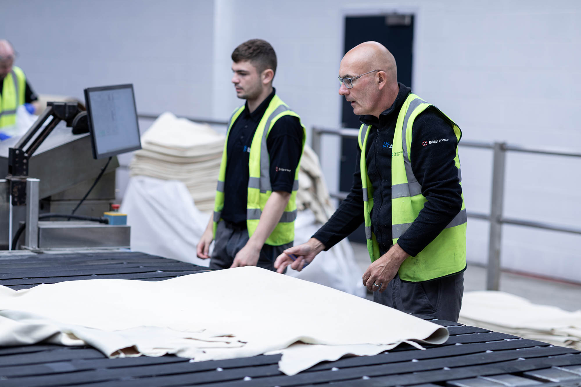 two men working in leather production