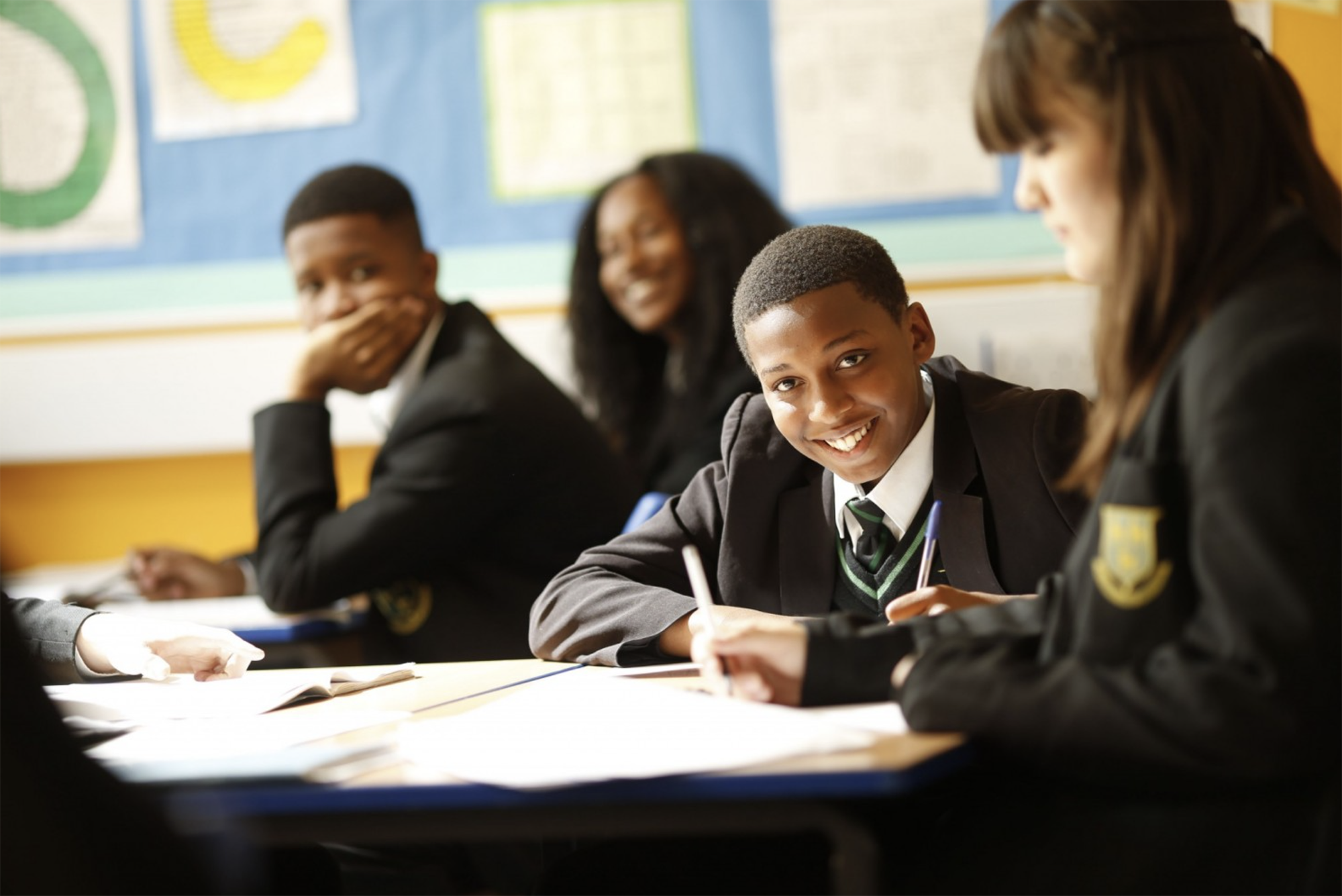 schoolchildren working at a desk