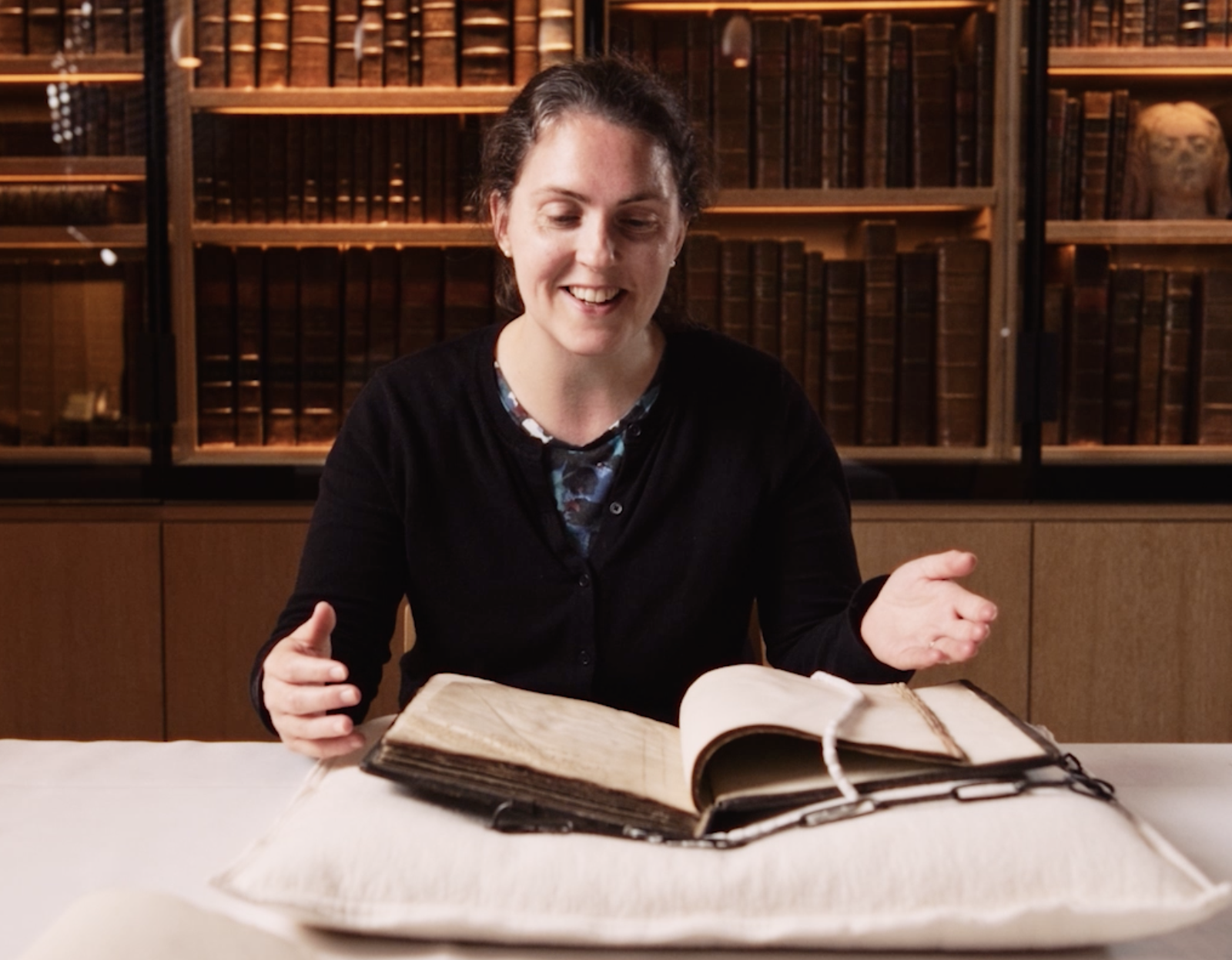 woman looking at a book smiling