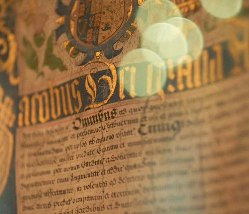 A medieval document with gold illuminated writing