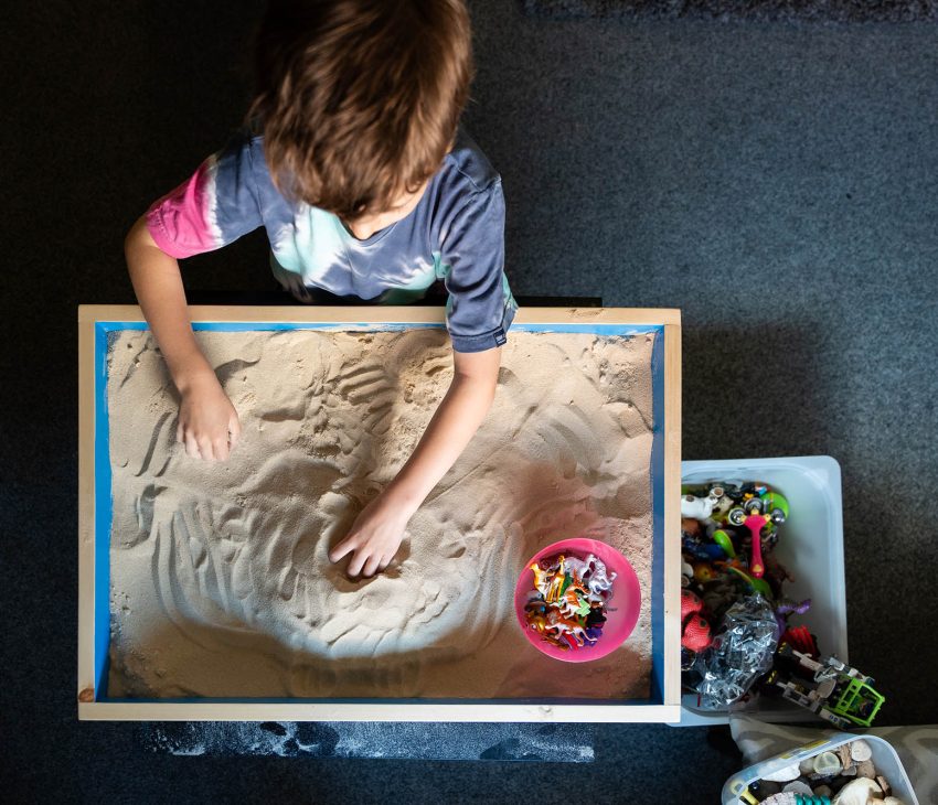 boy playing in sandpit
