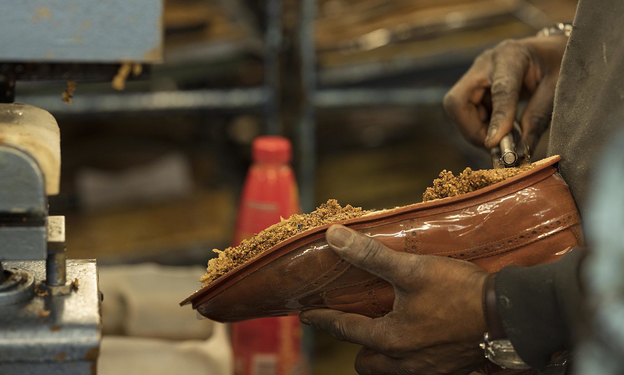 a shoemaker working on a shoe