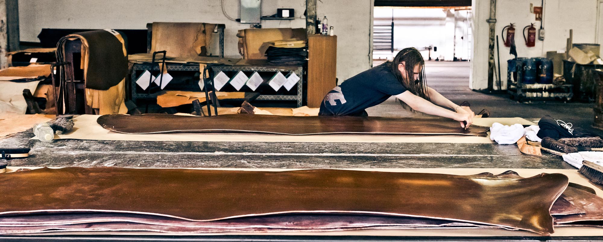 Man working on leather in a factory