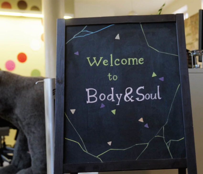 a blackboard with a toy bear in the background