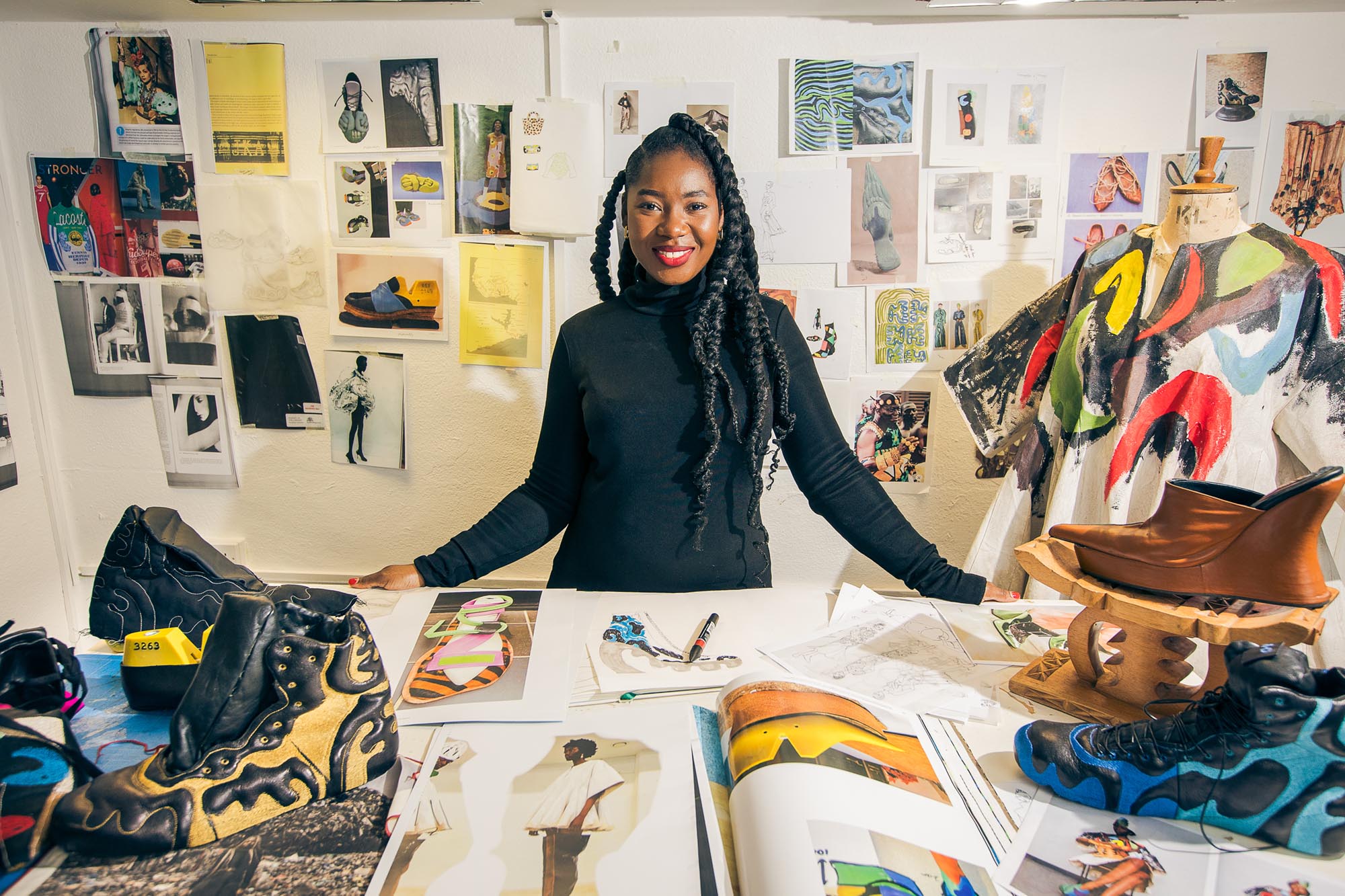 woman in a studio with shoes and shoe designs