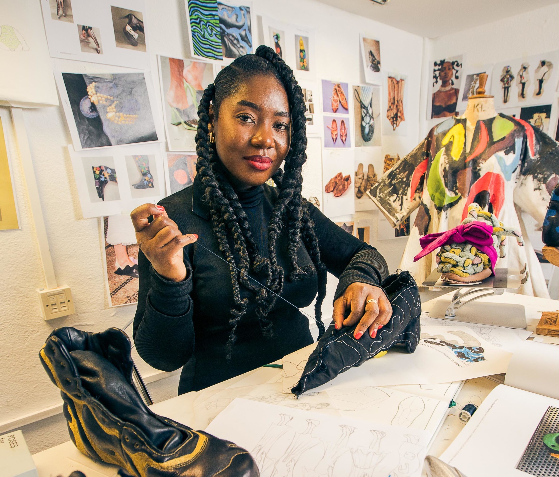 a woman in a studio making shoes