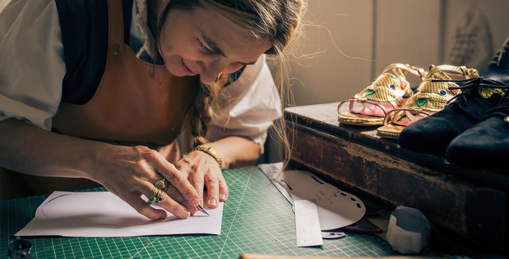 woman in a studio designing shoes