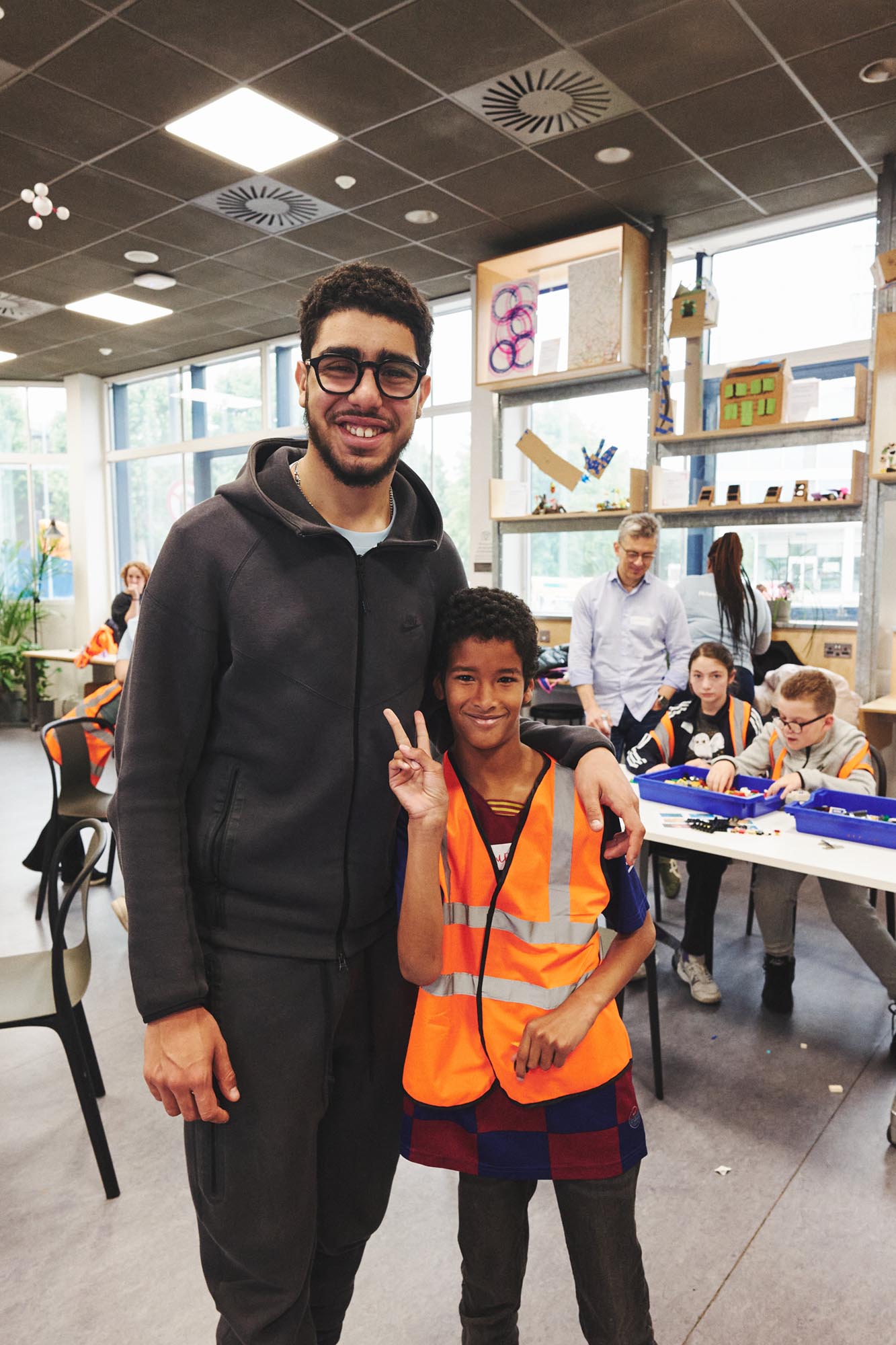 man standing with a child at a play group