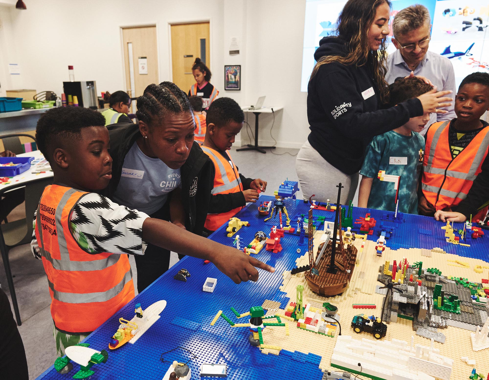 a child showing an adult a lego scene