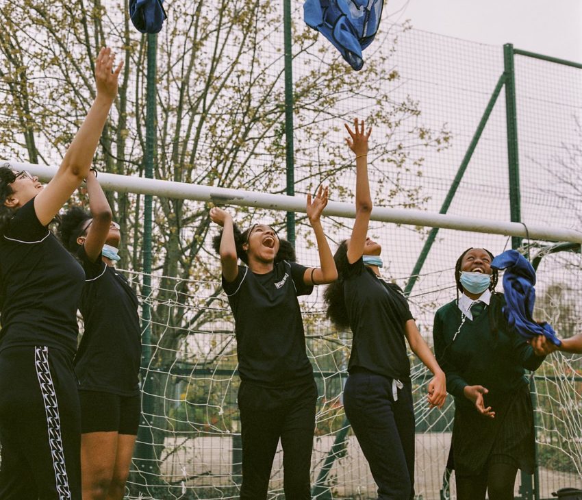 Children throwing t-shirts in the air