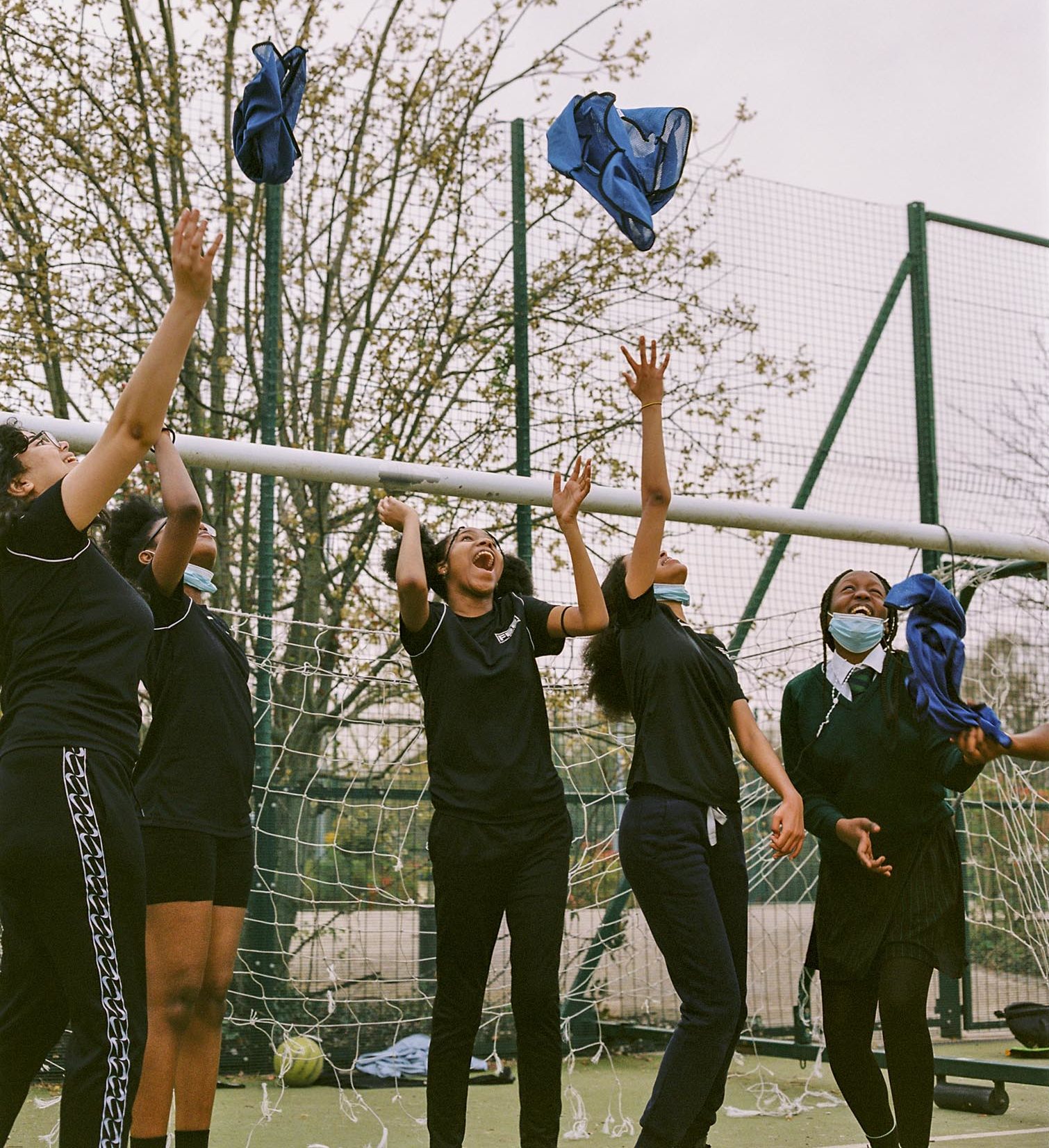 Children throwing t-shirts in the air