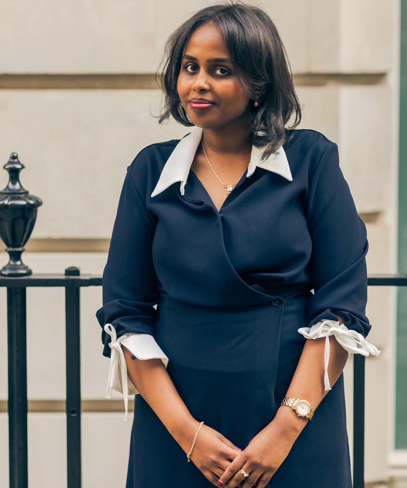 portrait of a woman with a stone building in the background