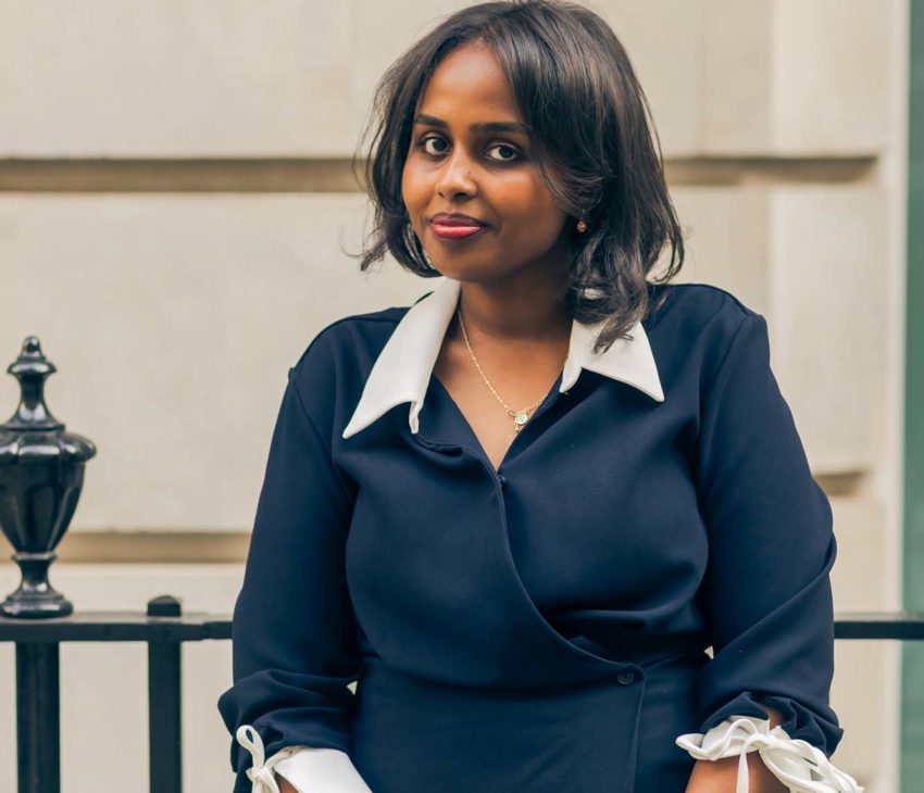 portrait of a woman with a stone building in the background