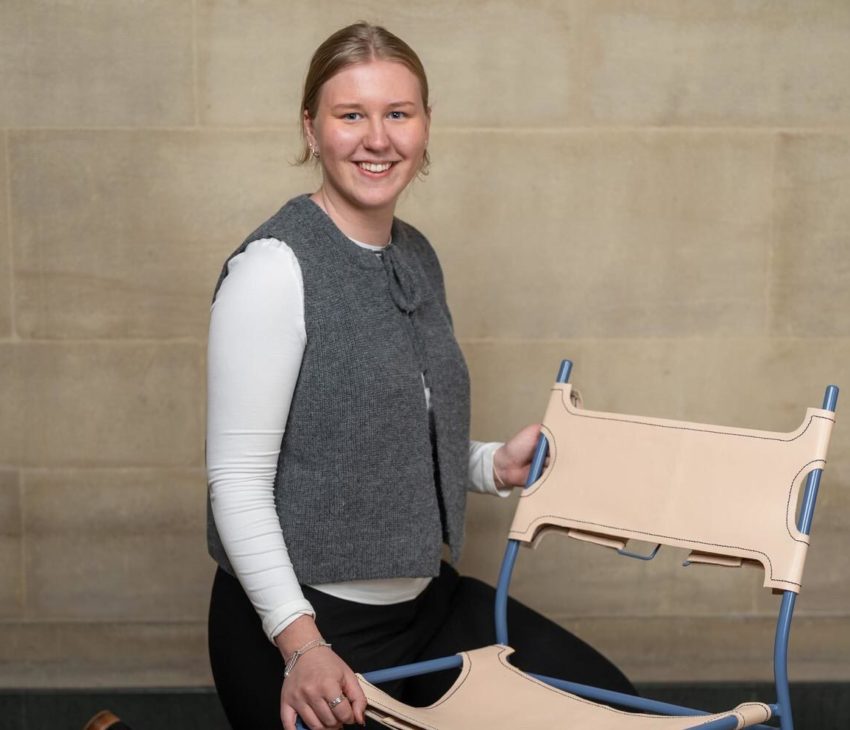 woman kneeling by a leather chair