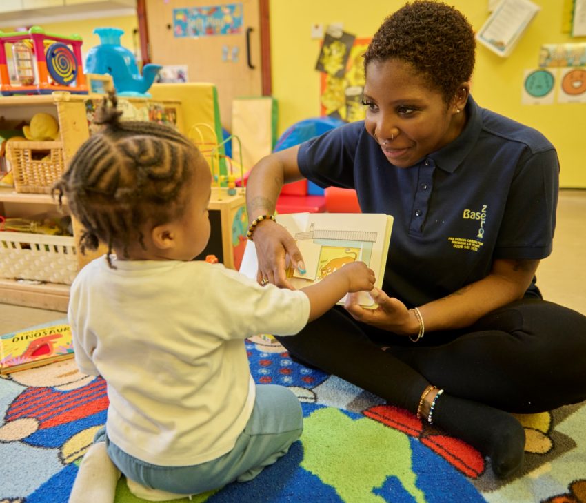 Child plays with volunteer