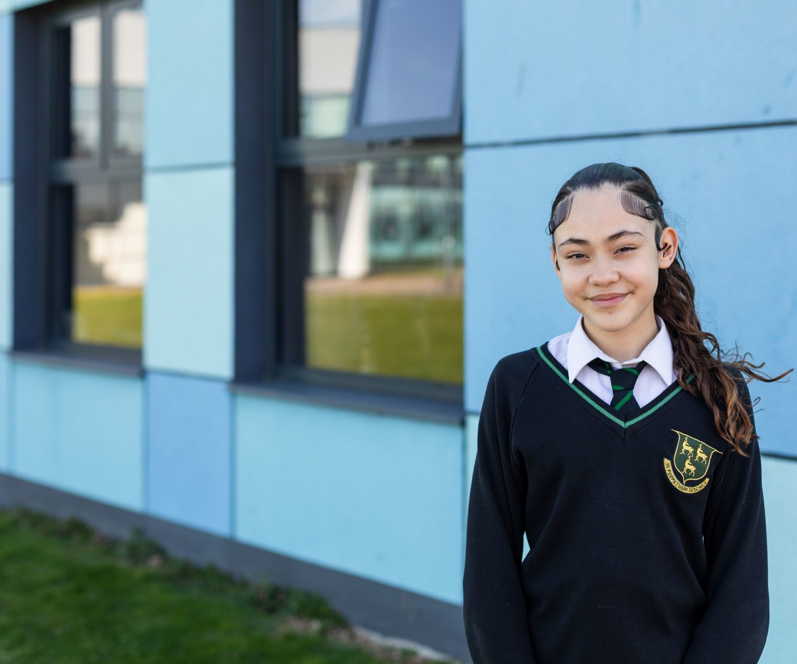 Student smiling into camera outside