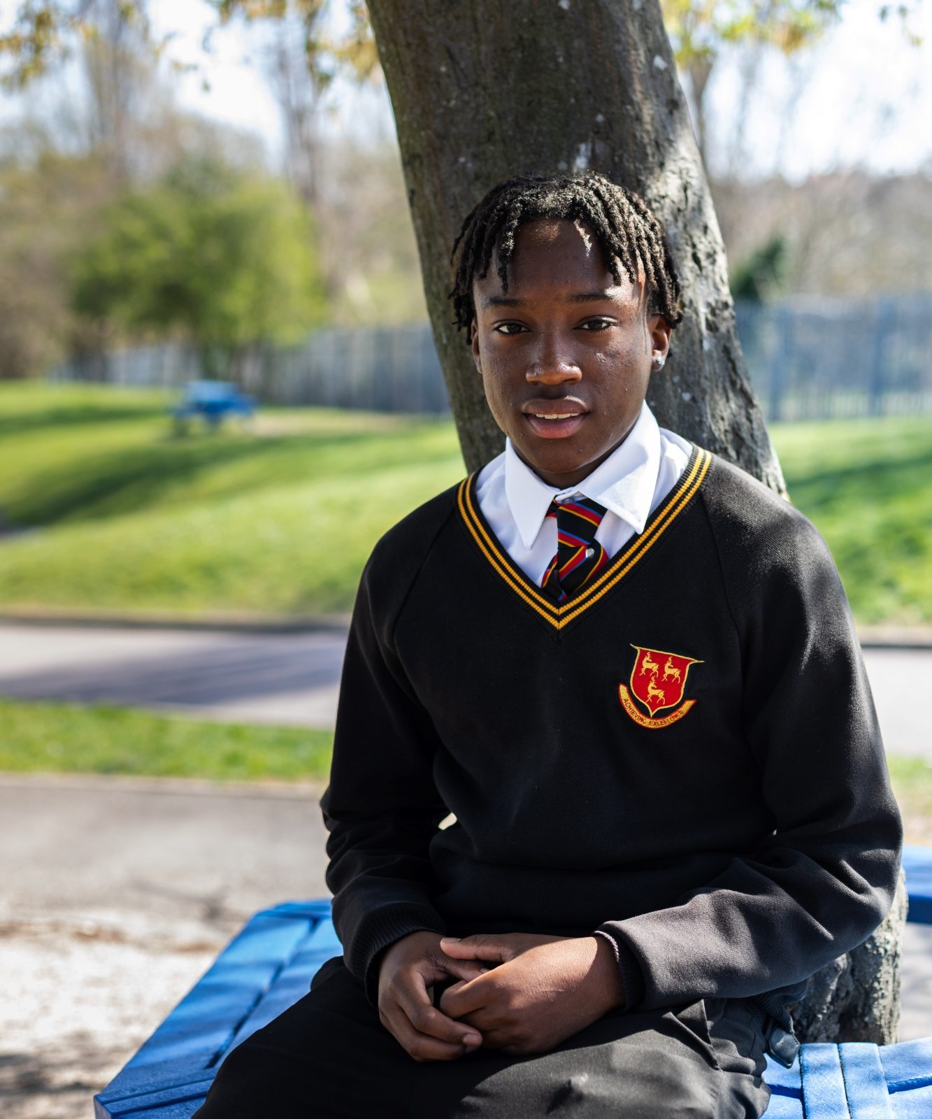 sitting student smiling into camera