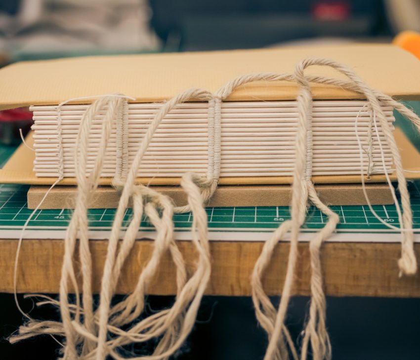 the side of a bound book, showing the stitching.