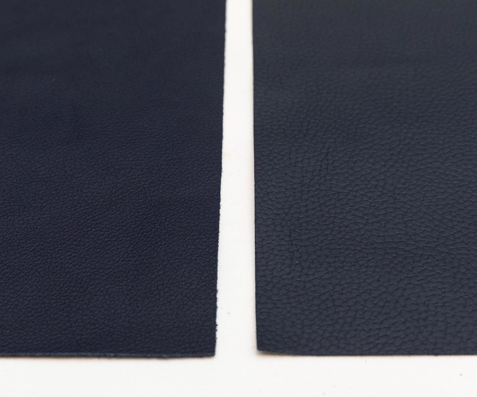 Two rectangular pieces of dark blue leather.
